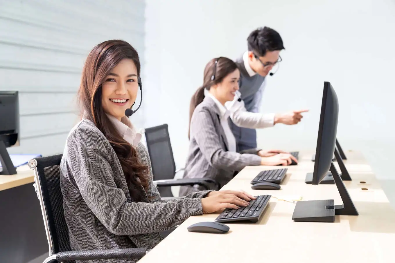 A girl is smiling while working in the call centre office